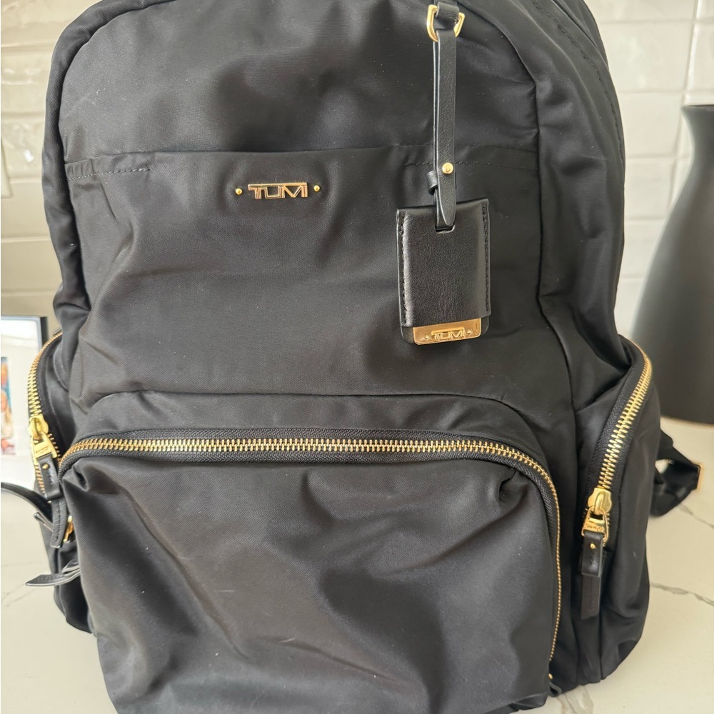 Tumi Black and Gold Backpack with Durable Design